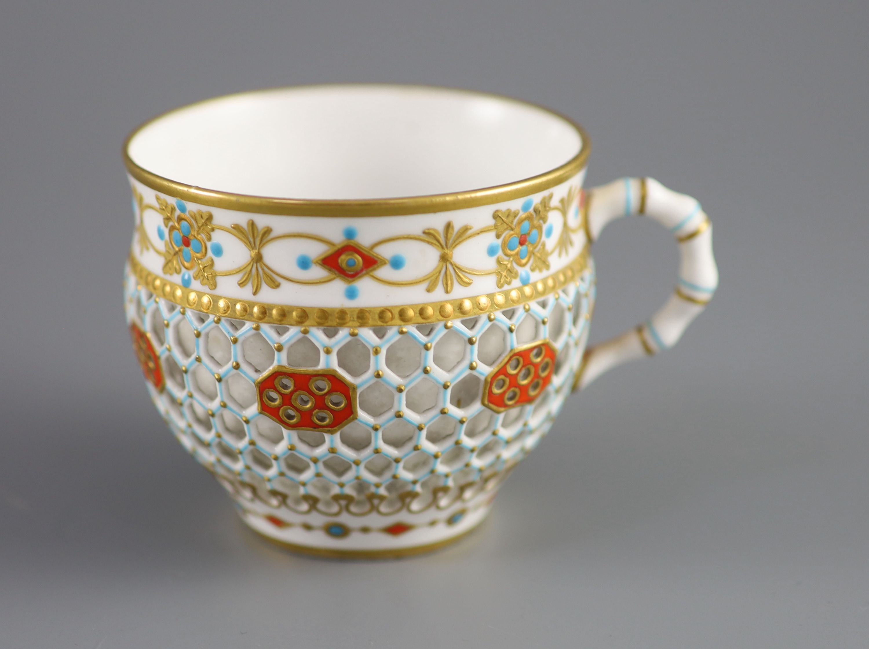 A Royal Worcester 'jewelled' and reticulated cup and saucer